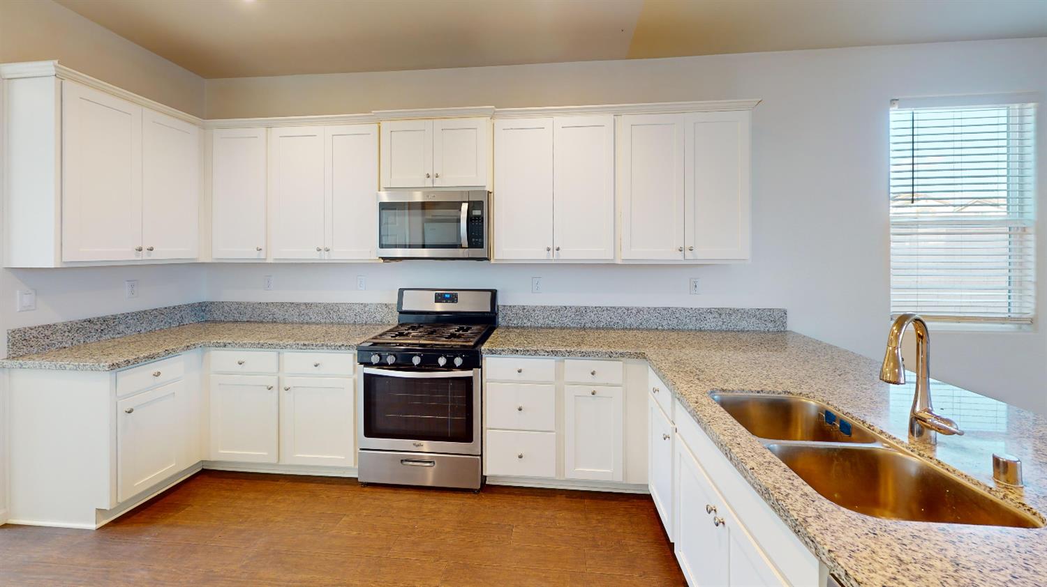 4826 North Casey Avenue Fresno, CA 93723 - Photo 20 of 36 a kitchen with granite countertop a sink a stove and cabinets
