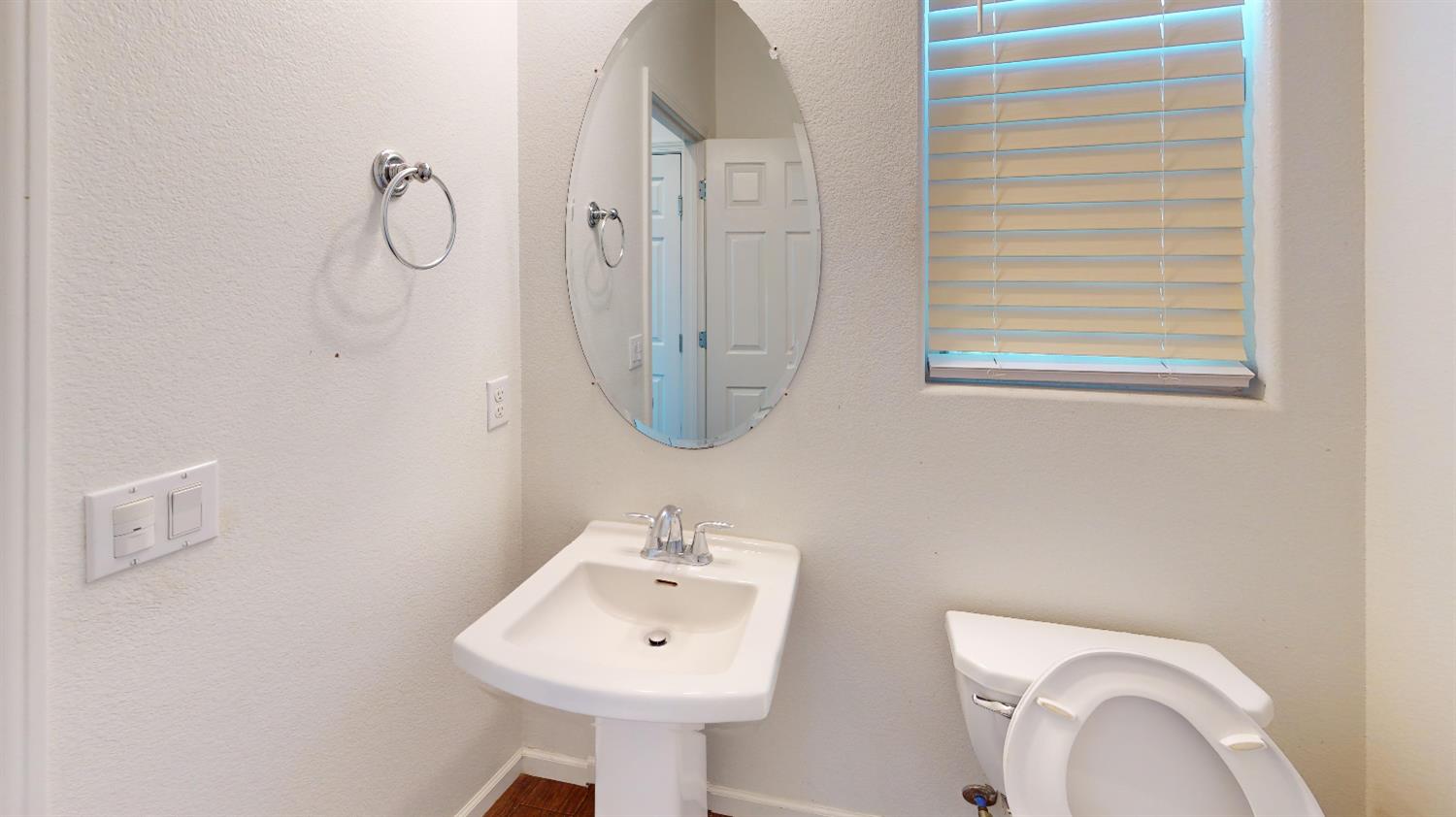 4826 North Casey Avenue Fresno, CA 93723 - Photo 4 of 36 a bathroom with a sink a toilet and a mirror