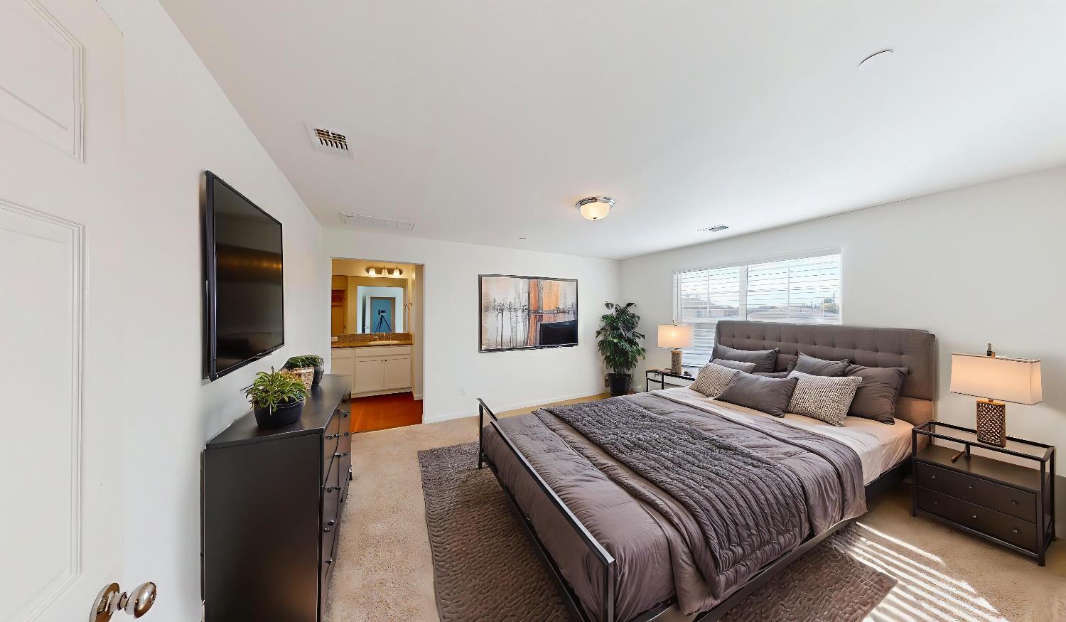 4826 North Casey Avenue Fresno, CA 93723 - Photo 8 of 36 a bedroom with a large bed and a couch