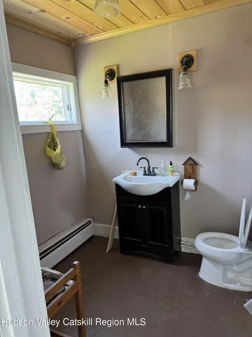 a bathroom with a toilet sink and mirror