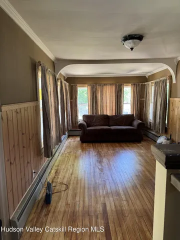 a living room with a couch and a wooden floor