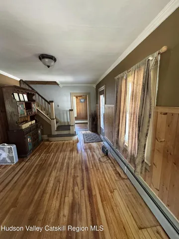 a view of a living room entryway with wooden floor