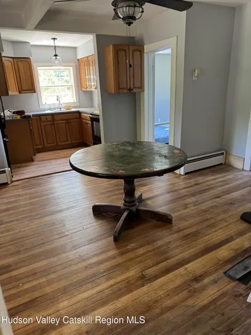a living room with wooden floor furniture and a window