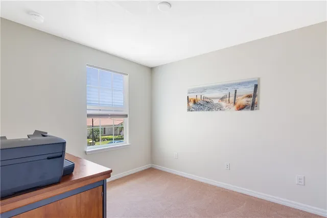 a room with a window and dresser