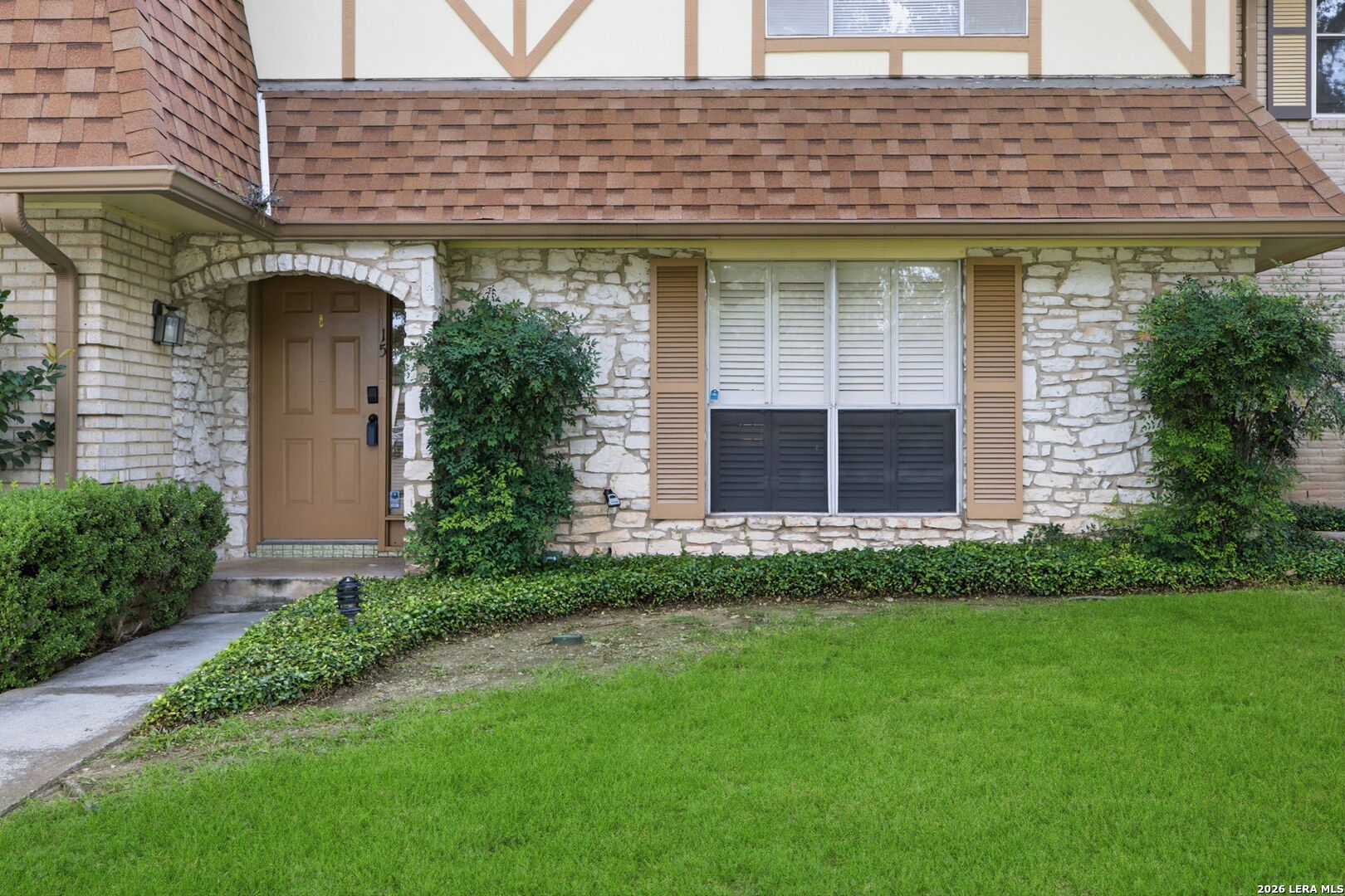 6106 Vance Jackson Road, Unit 15 San Antonio, TX 78230 - Photo 3 of 30 a front view of a house with a garden