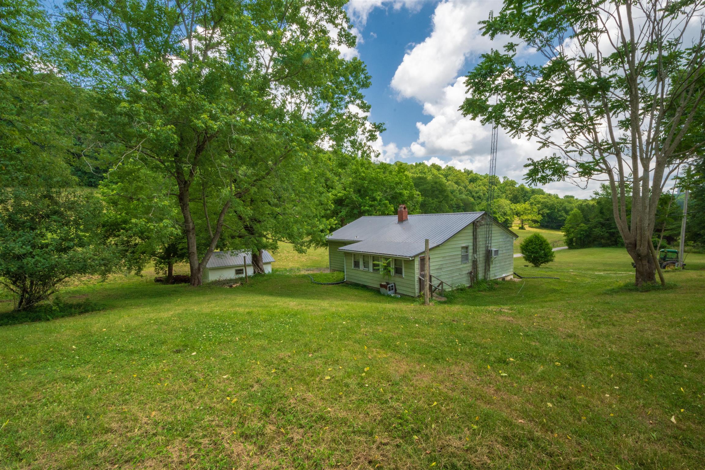 198 Ben Johnson Road Pulaski, TN 38478 - Photo 5 of 30 a white house in middle of the forest