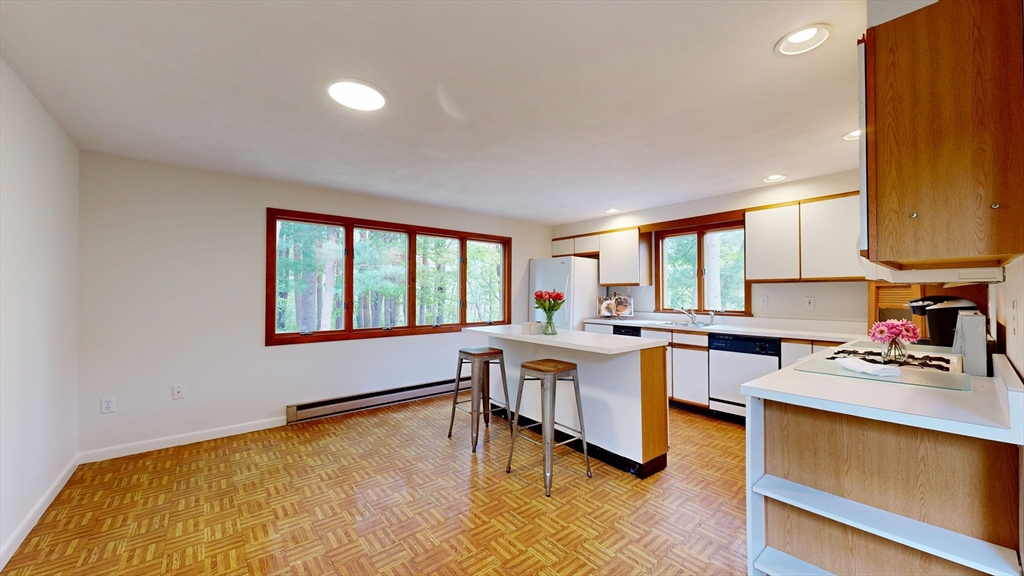 40 Anthony Road North Reading, MA 01864 - Photo 13 of 31 a kitchen with a sink a counter top space and living room area