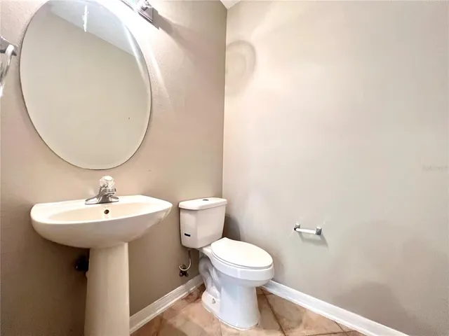 a bathroom with a toilet and a mirror