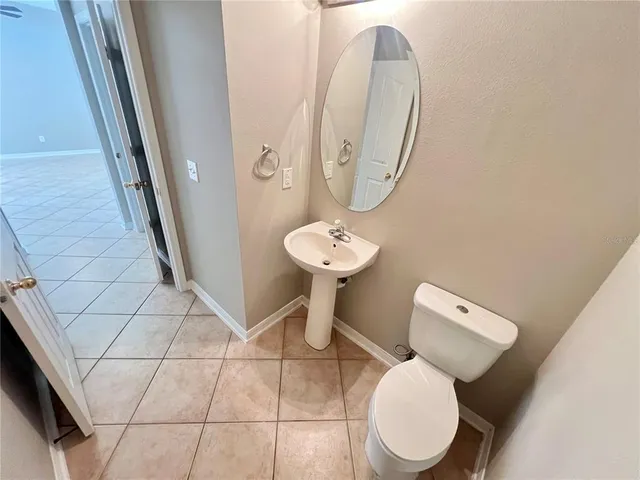 a view of a livingroom with wooden floor and a kitchen