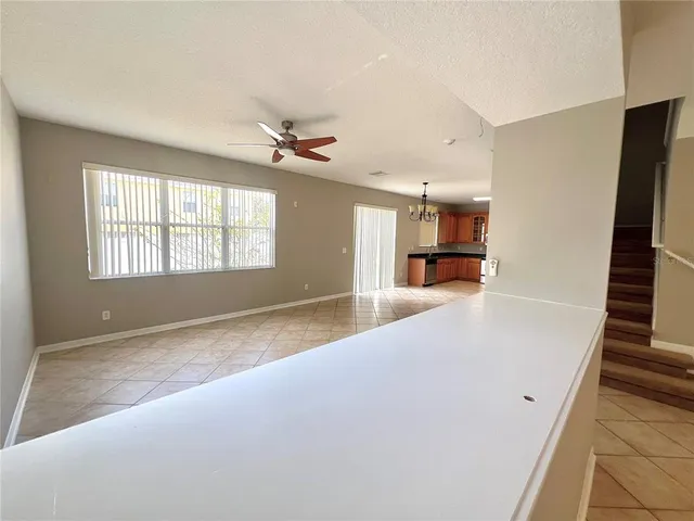 a view of an empty room with stairs and ventilation