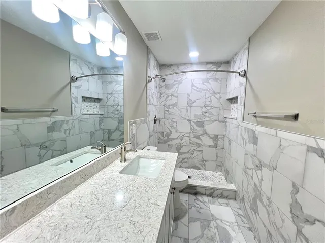 a bathroom with a shower curtain and a sink