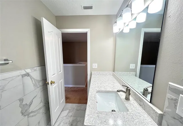 a view of an empty room with a ceiling fan