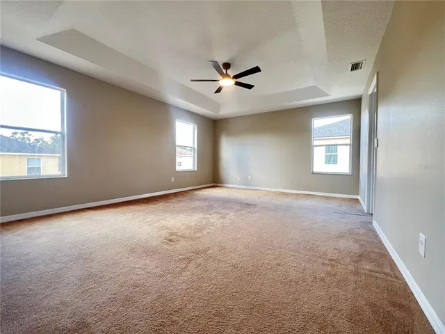 a bathroom with a granite countertop sink mirror and toilet