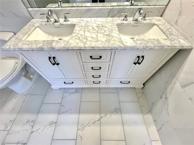 a spacious bathroom with a tub shower and a sink