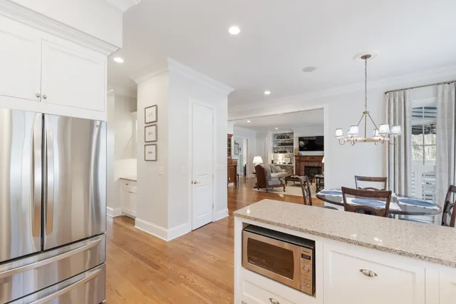 a kitchen with stainless steel appliances granite countertop a refrigerator and a sink