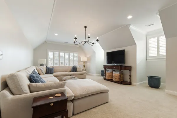 a living room with furniture a dining table and a flat screen tv