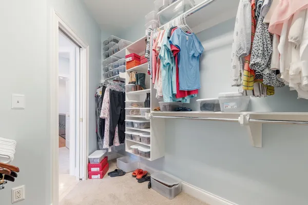 a bathroom with a granite countertop sink two mirror and shower