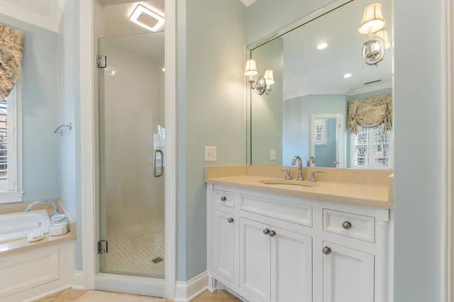 a bathroom with a granite countertop sink and a large mirror