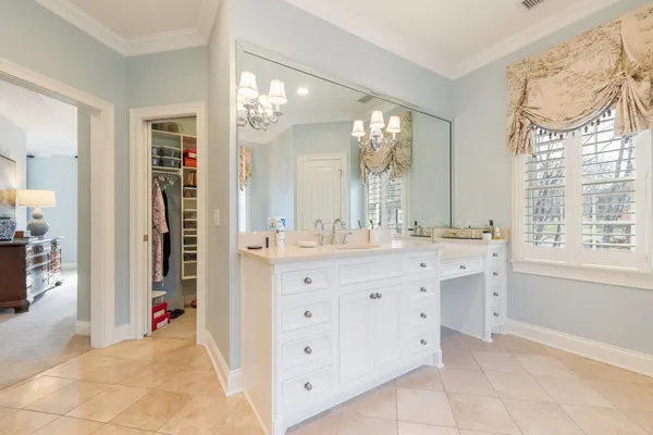 a bath tub sitting next to a white sink and vanity