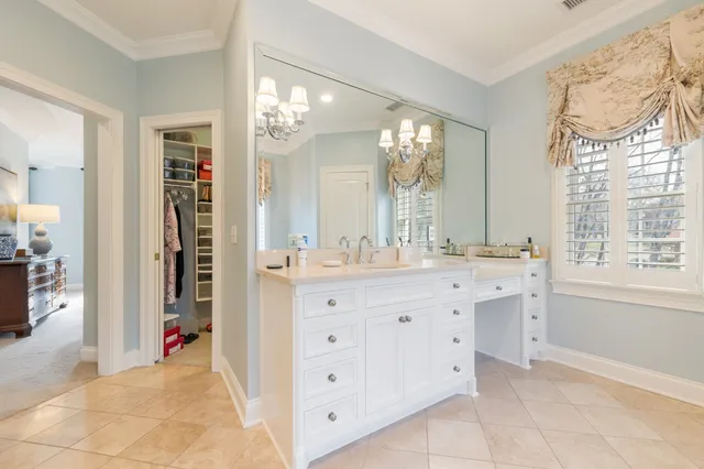a bath tub sitting next to a white sink and vanity