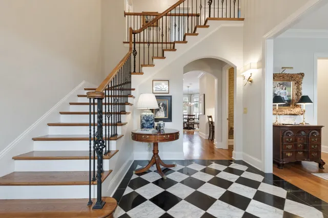 a view of entryway and hall with wooden floor