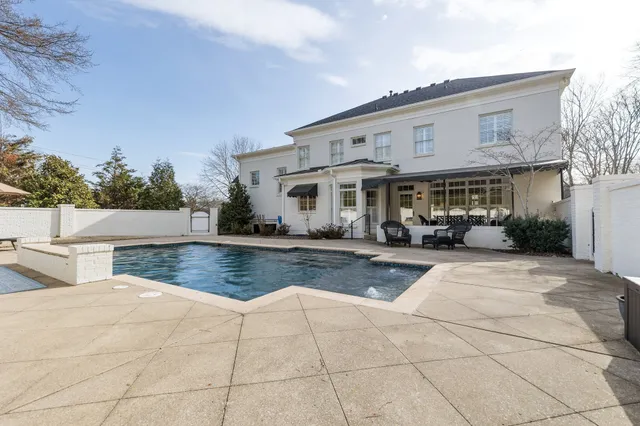 a view of house with outdoor space and sitting area
