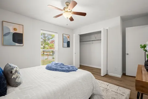 a bedroom with a large bed and a ceiling fan