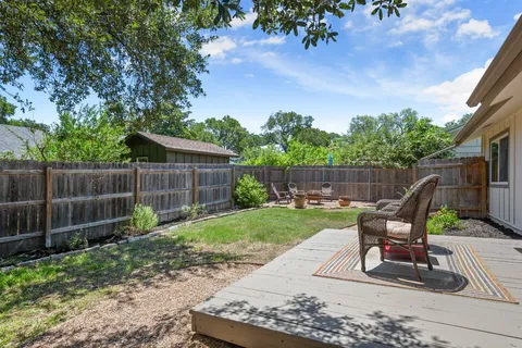 a view of a backyard with furniture and garden