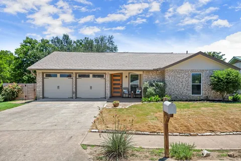 a front view of a house with yard patio and green space