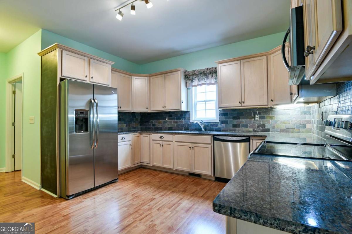 170 Meredith Ridge Road, Unit 8 Athens, GA 30605 - Photo 14 of 52 a kitchen with stainless steel appliances granite countertop a refrigerator a sink and a stove