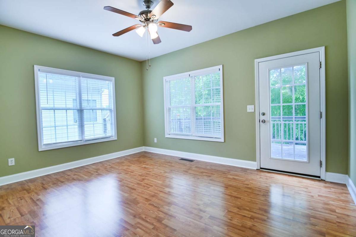 170 Meredith Ridge Road, Unit 8 Athens, GA 30605 - Photo 16 of 52 a view of an empty room with a window and wooden floor