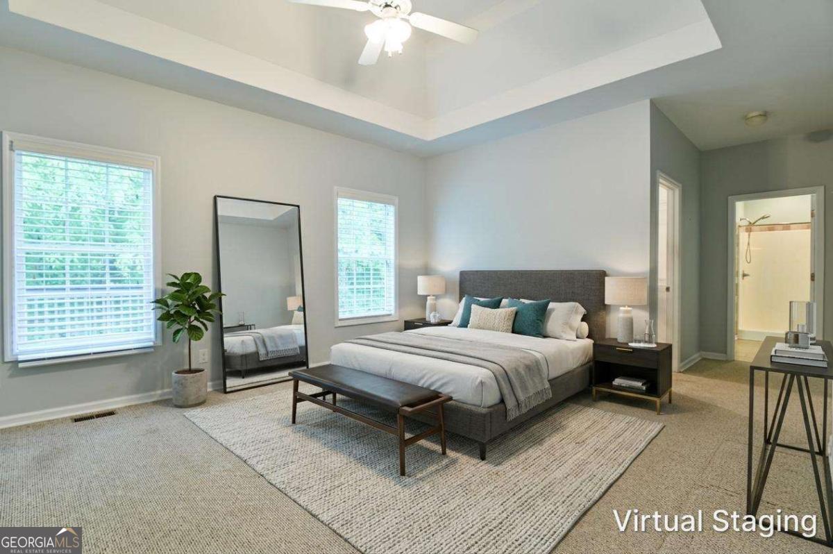 170 Meredith Ridge Road, Unit 8 Athens, GA 30605 - Photo 22 of 52 a spacious bedroom with a bed a table and chair