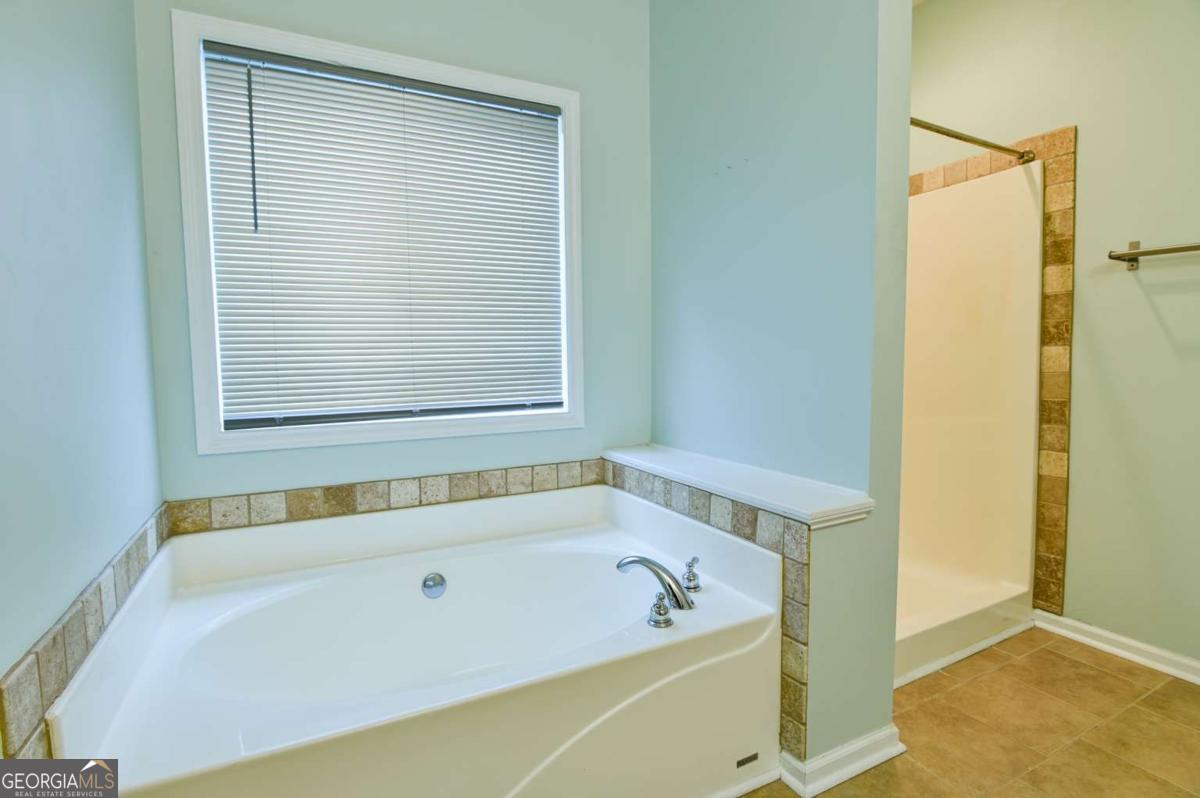 170 Meredith Ridge Road, Unit 8 Athens, GA 30605 - Photo 27 of 52 a white bath tub sitting next to a window