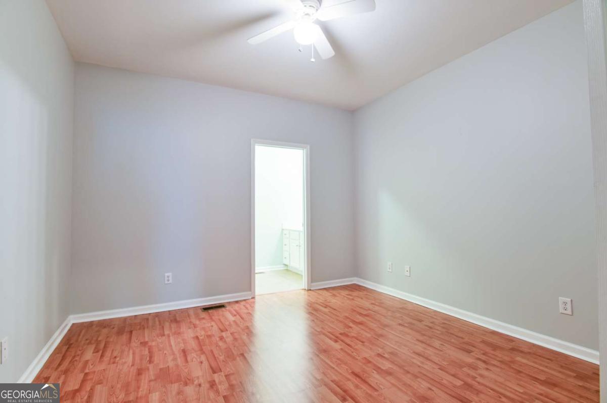 170 Meredith Ridge Road, Unit 8 Athens, GA 30605 - Photo 30 of 52 an empty room with wooden floor and windows