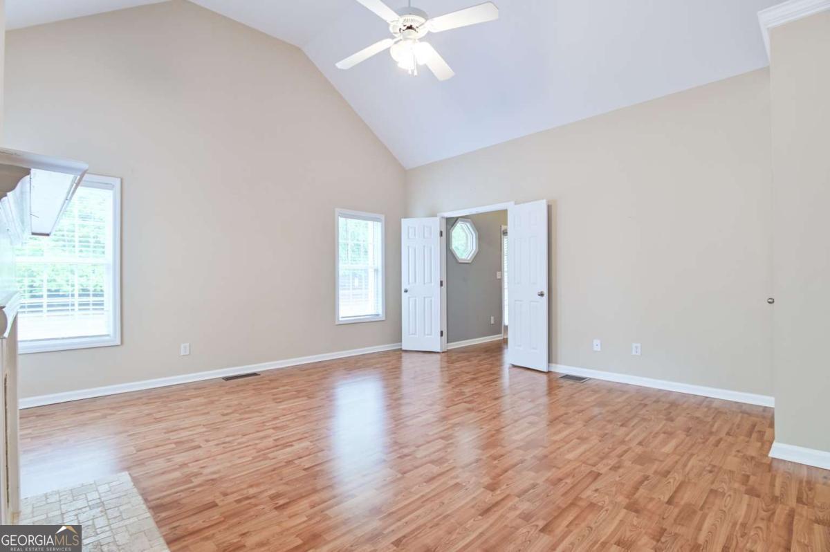 170 Meredith Ridge Road, Unit 8 Athens, GA 30605 - Photo 9 of 52 a view of an empty room with window and wooden floor