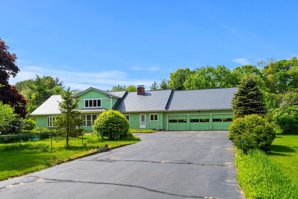 30 Bailey Road Andover, MA 01810 - Photo 2 of 37 a front view of a house with a yard and garage