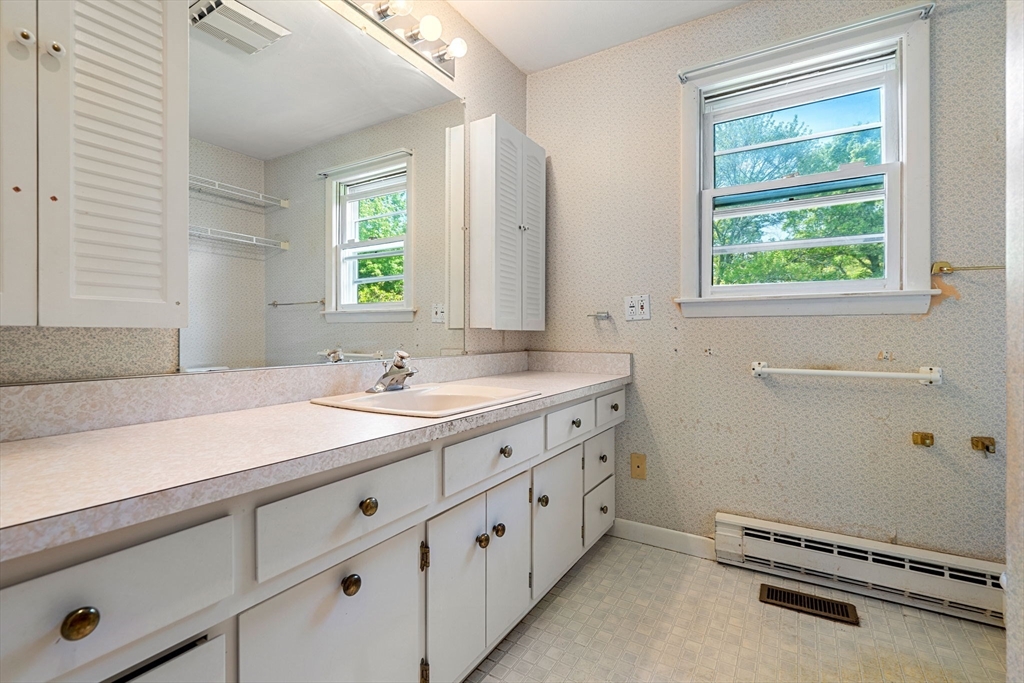30 Bailey Road Andover, MA 01810 - Photo 21 of 37 a bathroom with a double vanity sink a mirror and a window