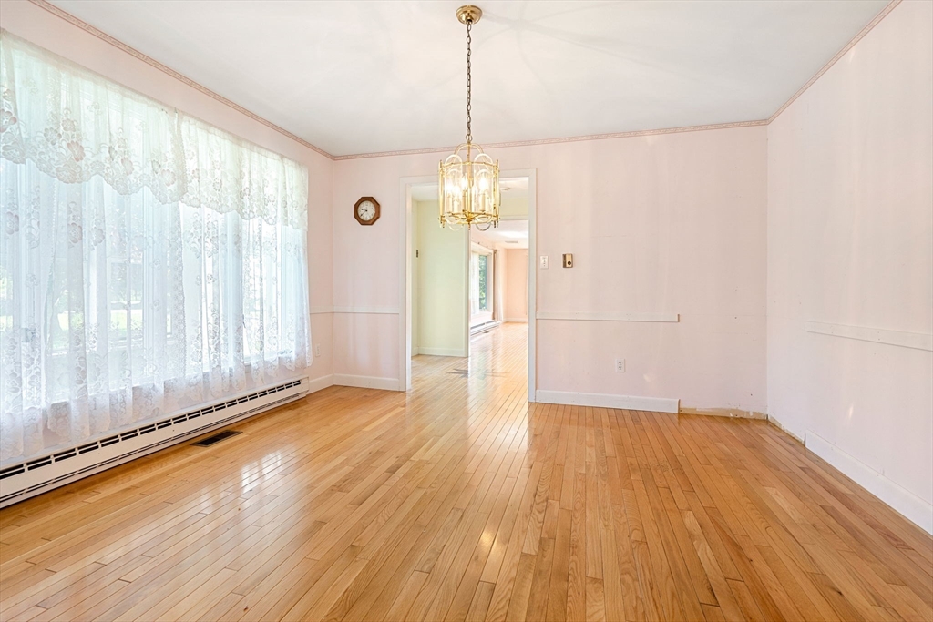 30 Bailey Road Andover, MA 01810 - Photo 8 of 37 a view of a room with wooden floor staircase and a kitchen space