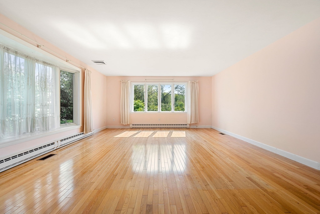 30 Bailey Road Andover, MA 01810 - Photo 10 of 37 an empty room with wooden floor and windows