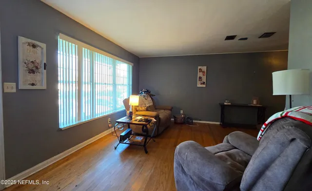 a living room with furniture rug and a window