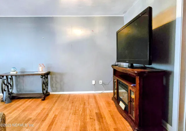a room with wooden floor and furniture