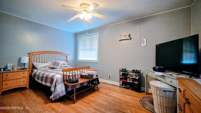 a bedroom with furniture and a flat screen tv