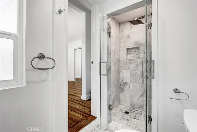 a bathroom with a shower and mirror