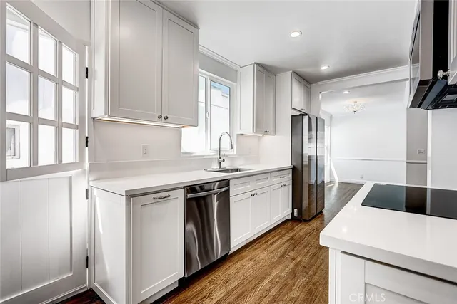a kitchen with a sink appliances and cabinets