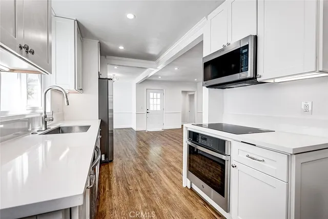 a kitchen with a sink stainless steel appliances and cabinets