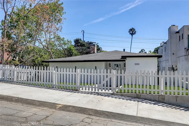 a front view of a house with a garden and pathway