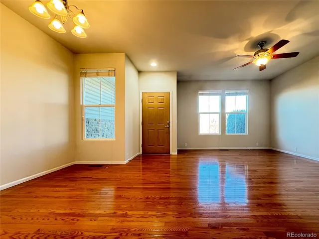 a view of entryway and hall with wooden floor