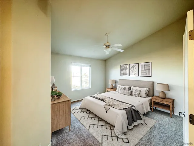 an empty room with a chandelier fan and windows