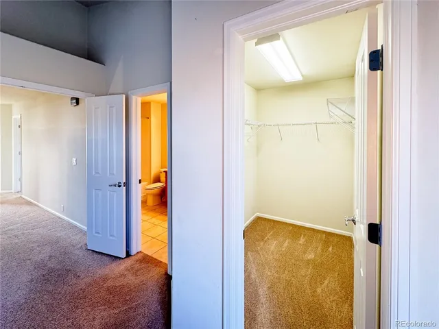 an empty room with a ceiling fan and a window