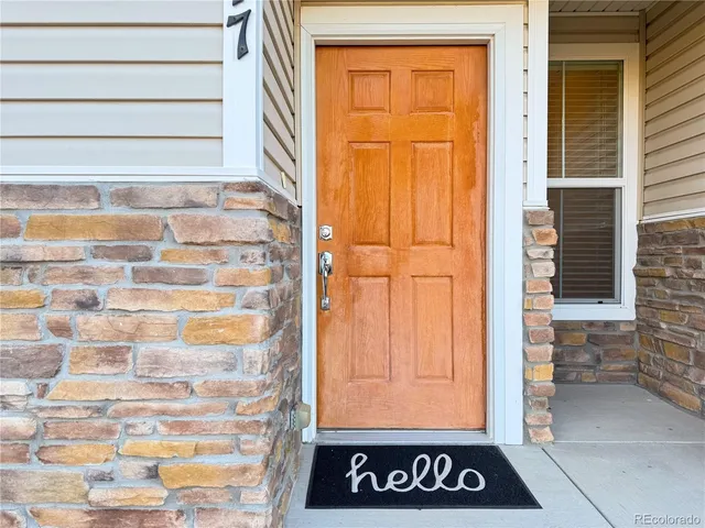 a living room with furniture and a dining table